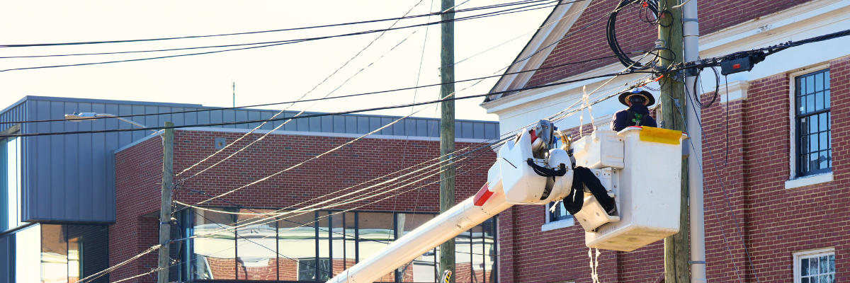 Electric worker in bucket truck working on powerlines