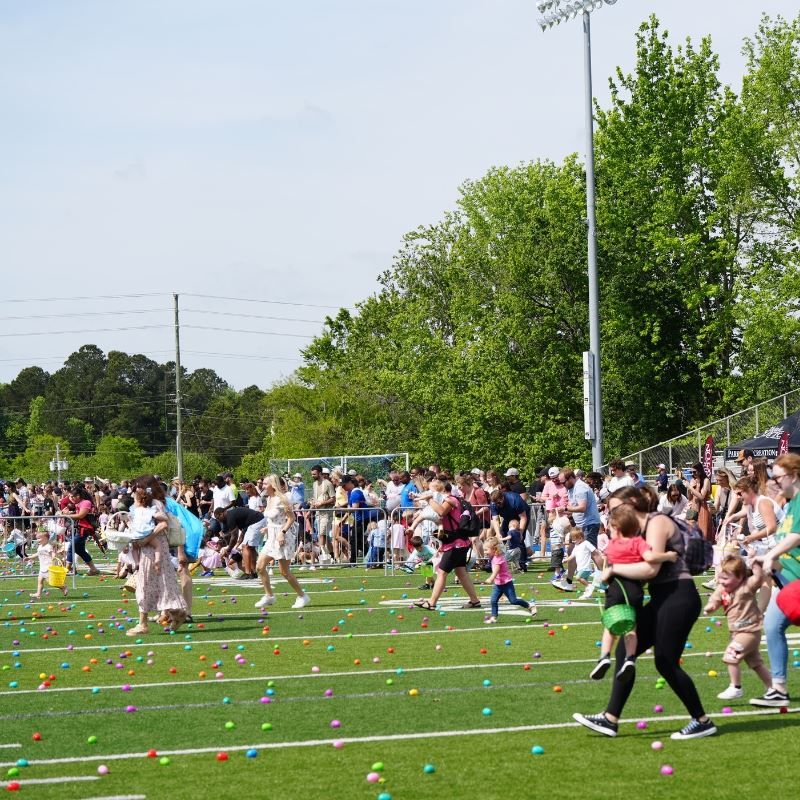 families rush clayton high school football field to gather easter eggs